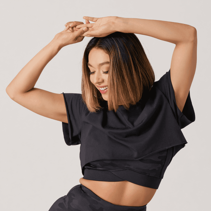 SR | Apparel Feature List Image - Female - Loose Black Top layered on Camo Sports Bra