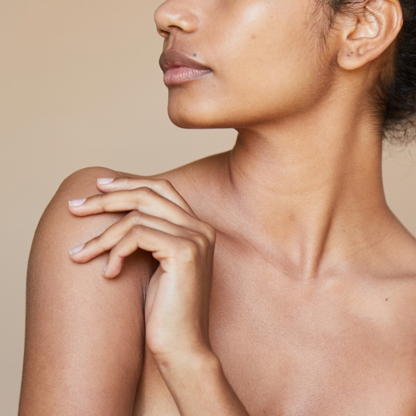 Woman showing her bare skin on her face and upper shoulders.