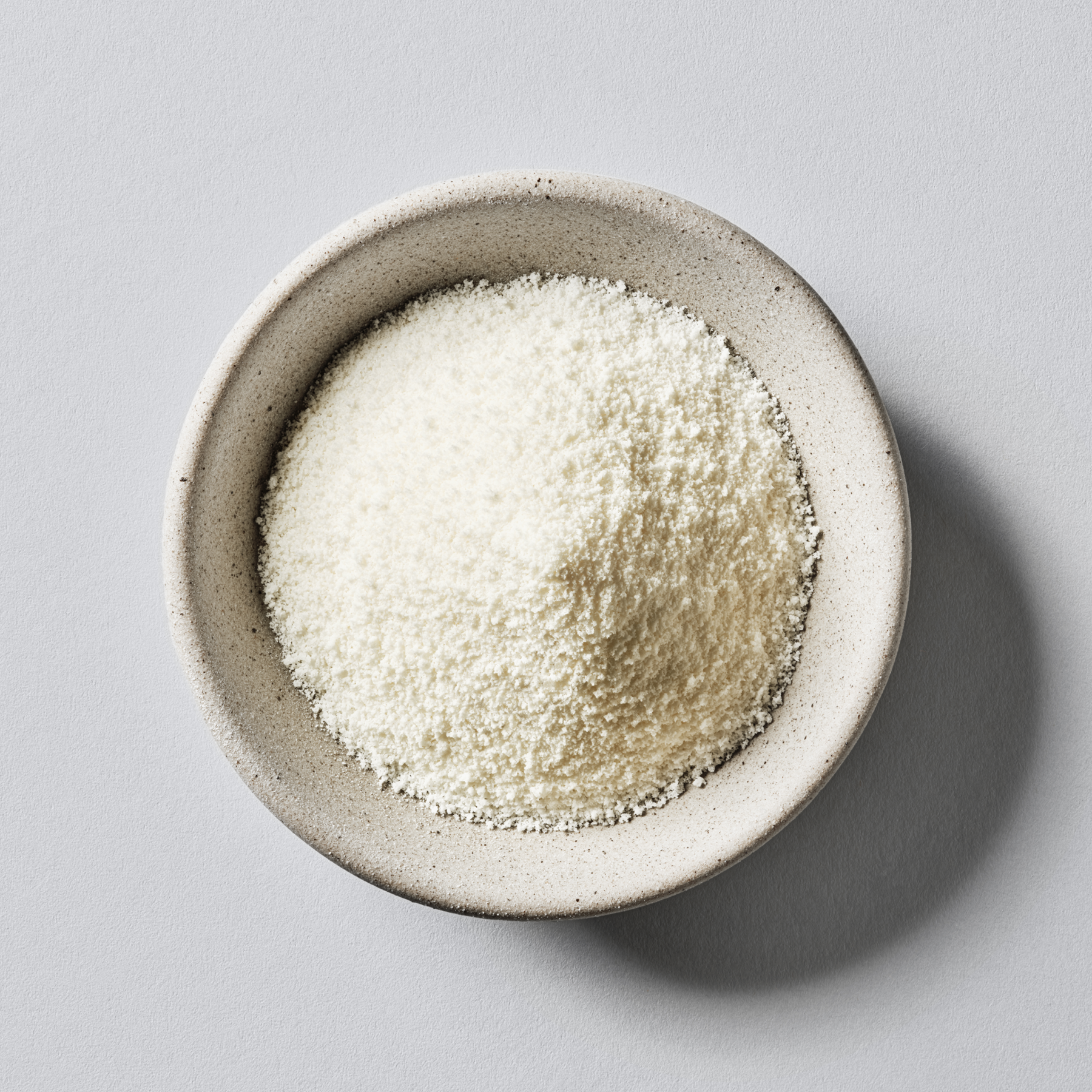 Sports Research Collagen Peptides Hydrolized Gelatin powder in a small ceramic bowl.