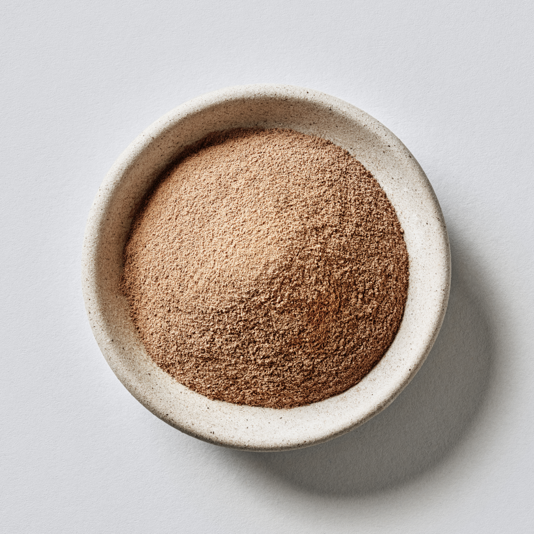 Sports Research Collagen Peptides Powder Chocolate in a ceramic bowl.